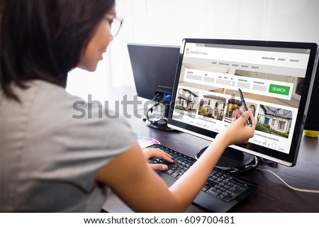 Composite image of property web site against woman watching her computer Royalty-Free Stock Photo #609700481