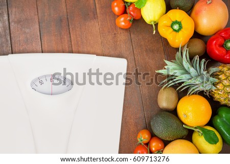 weighting scale against overhead view of assortment of fresh fruits