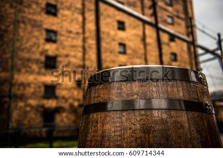 Vintage rustic bourbon barrel in front of building in Frankfort, Kentucky on the Bourbon Trail.  Royalty-Free Stock Photo #609714344