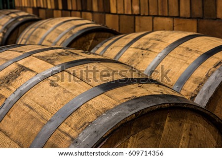 Vintage rustic bourbon barrel in front of building in Frankfort, Kentucky on the Bourbon Trail.  Royalty-Free Stock Photo #609714356