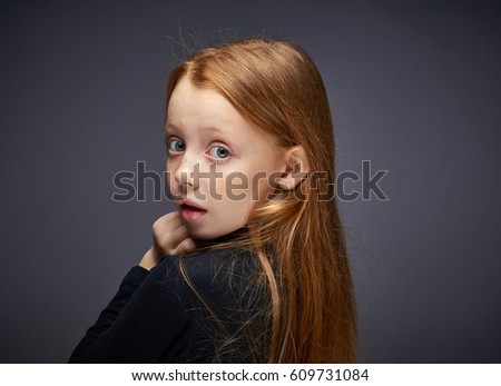 Little girl surprised, dark background