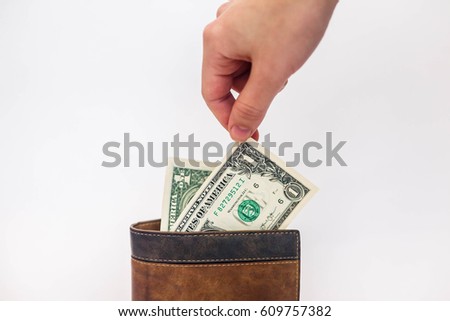 Hand pulled the dollar from leather wallet
