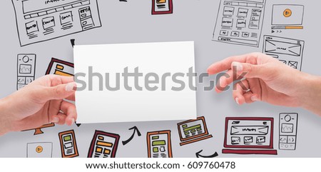 Hands holding card against grey background