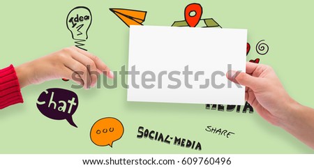 Hands holding card against green background