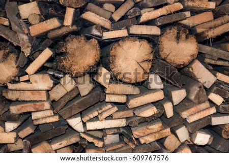 Natural wooden background, closeup of chopped firewood. Pile of wood logs.