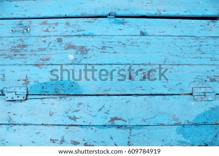 Vintage wood background with peeling paint. Blue paint
