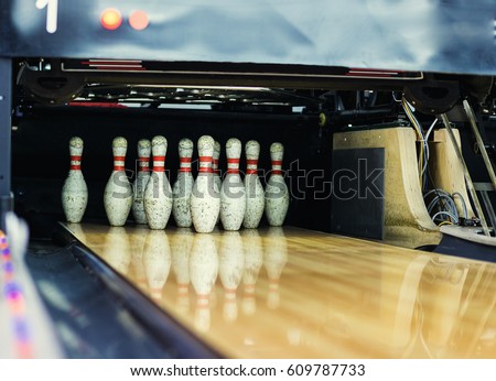 Pins at the end of a bowling alley,Skittles for bowling,bowling game