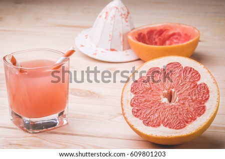 fresh citrus juice in a glass on a wooden table/fresh citrus juice in a glass