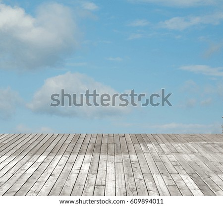 wooden floor against the sky with clouds