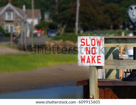 Slow No Wake Sign - Safety First. Boating lane in a harbor 