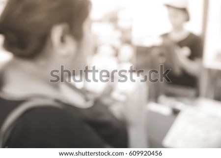 Picture blurred  for background abstract and can be illustration to article of Woman use smartphone shopping at shop
