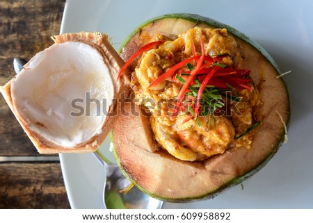 Top View of Curry Streamed Seafood in Coconut on wooden table