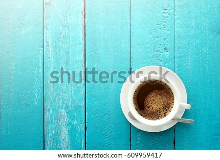 Top view of coffee cup on a ocean blue wood table background with copy space summer time concept