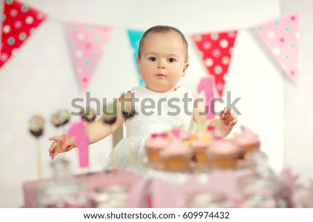 Beautiful happy baby on first birthday background.
