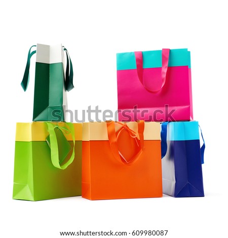 Stack of colorful shopping or gift bags isolated over the white background