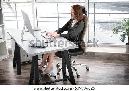 Posture concept. Young woman working with computer at office Royalty-Free Stock Photo #609986825