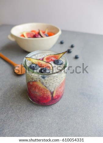 Homemade healthy snacks of chia seeds,soy milk,fresh figs,blueberries,frozen blackberries,red currants and raspberries / Berry Chia Seed Pudding / Vitamins and mineral enriched,high in dietary fiber