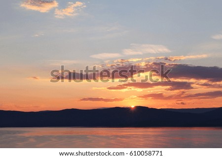beautiful sunset landscape on background of lake and mountains. large lake and silhouette of mountains at sunset. Southern Ural, lake Turgoyak, Russia. atmosphere  scenic nature view