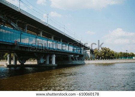 Covered pedestrian bridge over the river on a summer day