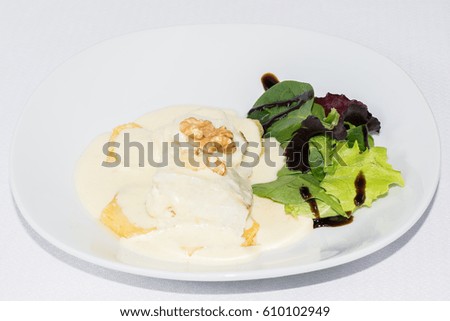 Top cod with leek sauce and walnuts and lettuce