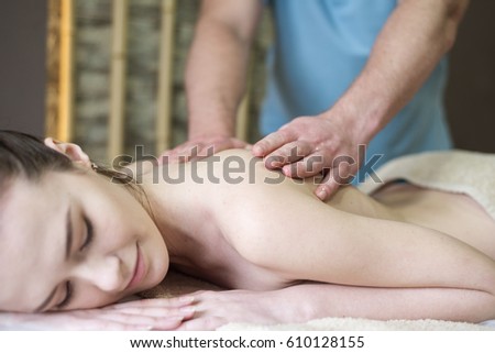 Body care. Spa body massage treatment. Woman having massage in the spa salon Royalty-Free Stock Photo #610128155