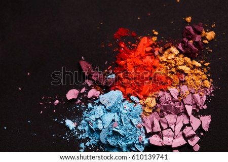 Beauty, makeup cosmetics. Eyeshadow splash palette, colorful crushed eye shadow powder, flat lay, top view, black background, shallow depth of field