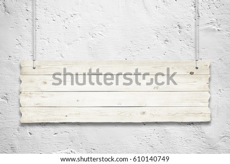 Wooden sign with ropes isolated over wall background
