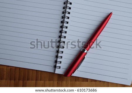 red pen on notebook paper