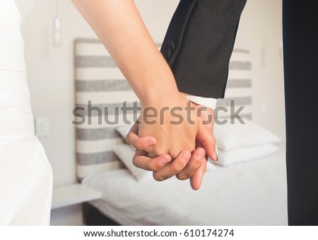 Digital composite of Wedding couple holding hands by bed
