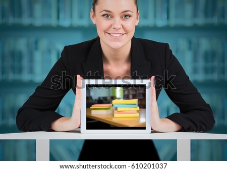 Digital composite of Business woman with tablet showing book pile against blurry bookshelf with blue overlay