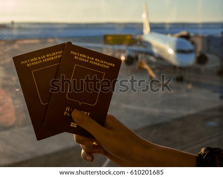 Passport on the background of an airplane with a setting sun