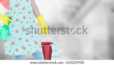 Digital composite of Woman lower body in apron with bucket against blurry grey background