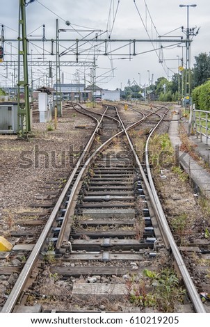 Rail tracks leading into junctions and continuing on into the distance.