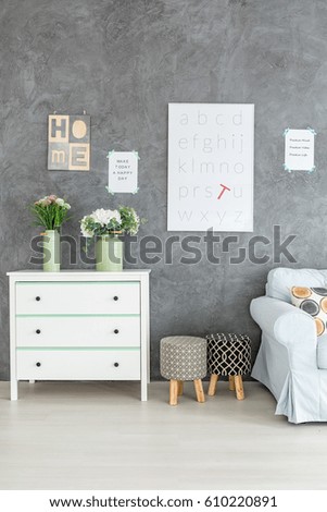 Grey room with white poster on the wall