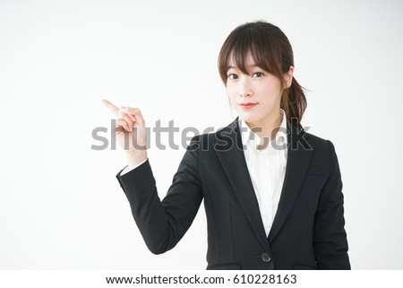 Young business woman pointing something with smile