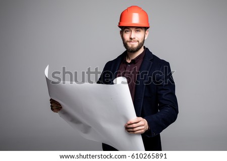 Portrait of an architect builder studying layout plan of the rooms, serious civil engineer working with documents on construction site. Royalty-Free Stock Photo #610265891
