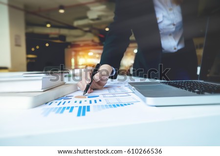 Business woman hand pointing  business document during discussion at meeting discussion and analysis data the charts and graphs showing the results at meeting.Business finances and accounting concept Royalty-Free Stock Photo #610266536