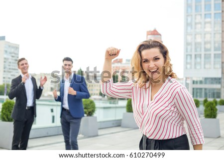 Young woman raised his arms up as a sign of victory and success in business. Concept - business champion.