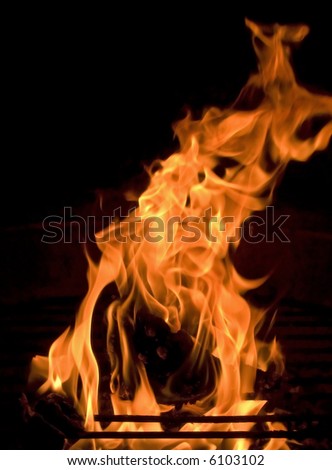 Flames dancing at night over an outdoor fireplace