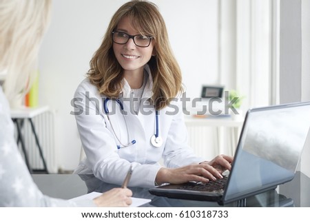 Shot of a middle aged female doctor sitting in front of laptop and consulting with her patient.
