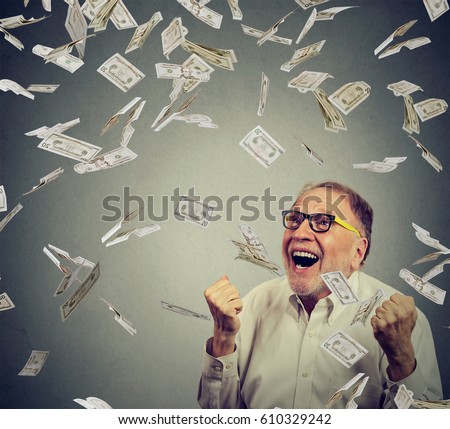 Senior man celebrates success under money rain, falling down dollars