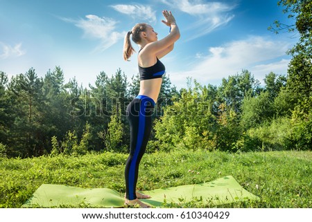 Young athlete engaged in a park. Stretching. Pilatess. Yoga. Healthy lifestyle. Mock up