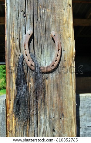 Horseshoe hanging on a wood pole