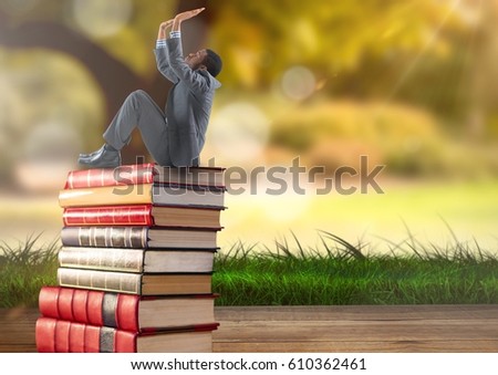 Digital composite of Businessman sitting on Books stacked by greenery nature