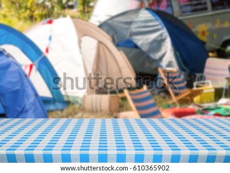 Digital composite of Picnic table against blurry campsite