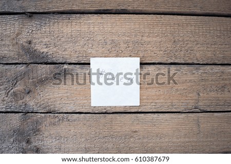 A piece of paper on a wooden background