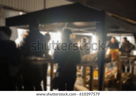Blur image of people standing, outdoor party celebration at night.