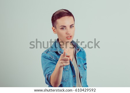 Attention, you listen to me. Close up portrait of young woman wagging her finger isolated green wall background. Negative human emotions face expression life perception feelings body language attitude