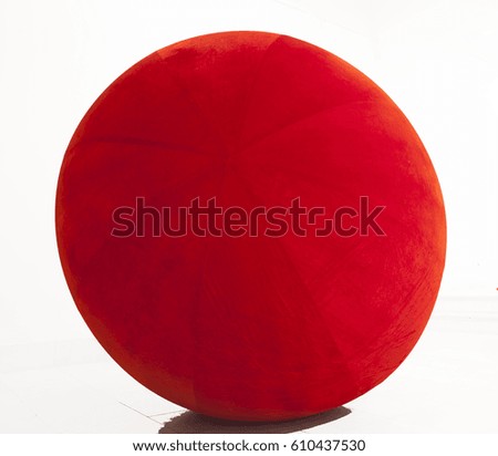 Red plush ball, with small shadow, isolated Royalty-Free Stock Photo #610437530
