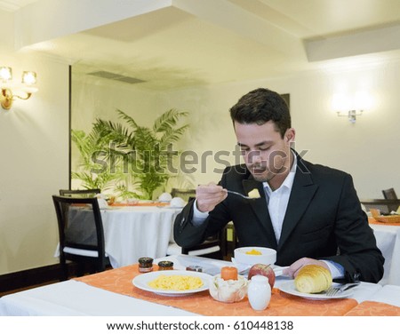 Businessman takes breakfast in hotel